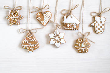 Christmas gingerbread of different kinds on a black and white wooden background