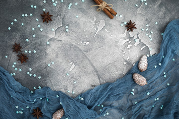 Christmas frame made of snowflakes, cinnamon and pine cones on dark background. Flat lay. Top view