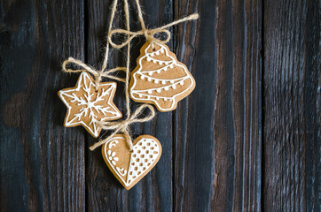 Christmas gingerbread of different kinds on a black and white wooden background