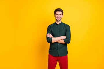 Photo of cheerful positive nice man with good mood standing confidently with arms crossed smiling...