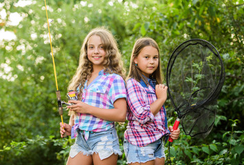 Good day for fishing. children with net and rod. summer holidays weekend. Fly Fishing Time. little kids spend time in camp. having fun. fish angler. two girls fishing. Big game fishing. summer hobby