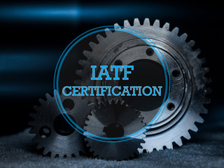 IATF Certification Logo in blau mit Industrie Hintergrund