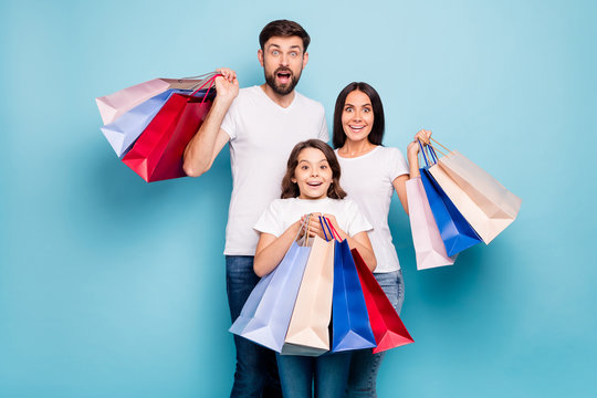 50 off. Real bargain concept. Portrait of excited three people mom dad schoolkid shop center hold bags scream wow omg wear white t-shirt denim jeans isolated over blue color background