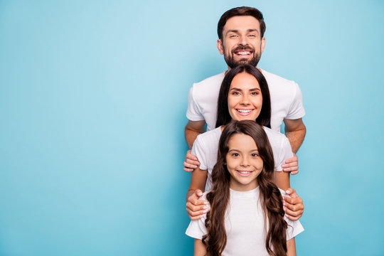 Portrait of positive cheerful stack of mommy daddy kid with wavy curly hairstyle enjoy relax rest feel dream wear white stylish t-shirt casual style isolated over blue color background