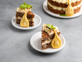 Chocolate and nuts cake with cream cheese, dried pears and mint leaves