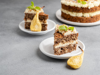 Chocolate and nuts cake with cream cheese, dried pears and mint leaves