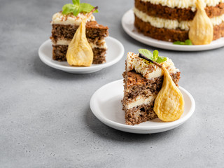 Chocolate and nuts cake with cream cheese, dried pears and mint leaves