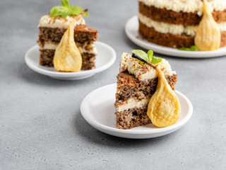 Chocolate and nuts cake with cream cheese, dried pears and mint leaves