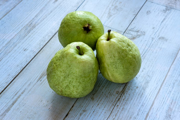 Fresh guava fruit on a wooden background