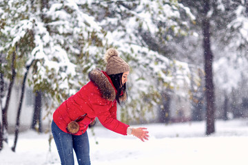  girl playing with snow on winter day.Happy holiday.