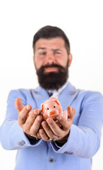 Businessman holds broken piggy bank. Financial crisis. Business problems. Credits and loans. Saving and protecting money concept. Business man with breaking piggy bank in hands. Selective focus.