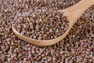 Groats on a wooden spoon.