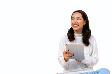 Fototapeta premium close up young beautiful asian woman holding digital tablet and looking away with toothy smile isolated on white background for advertisement banner and billboard design concept