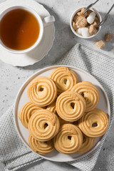 Cookies on a white ceramic plate on the gray kitchen table. Top view with copy space