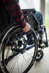 Obraz premium Close Up Of Man Sitting In Wheelchair At Home By Window