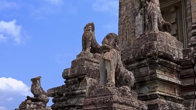 4K, Stone Lion Guardian along the stairway with blue sky and clouds at Pre Rup, The East Baray. General sight and statues of vigilant lions at the archaeological temple in Siam Reap, Cambodia.-Dan