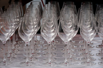 A lot of empty wine glasses in a row
