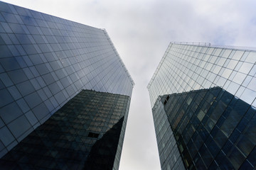 Fototapeta na wymiar Two skyscrapers from below