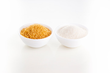 Brown natural cane sugar and plain white granulated sugar in white rosettes