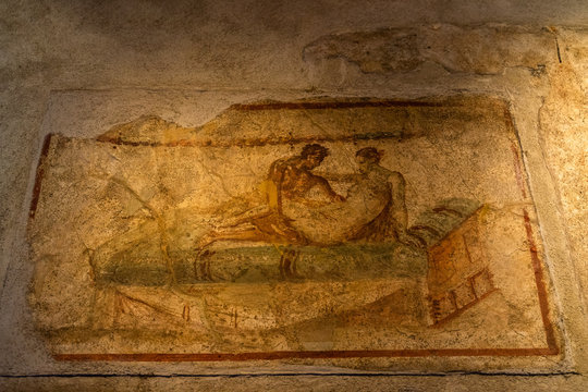 Sexual scene from a wall painting at the Lupanare, the most famous brothel in Roman city of Pompeii, Italy