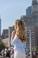 Fototapeta na wymiar Blonde woman in blue shirt posing in Boston