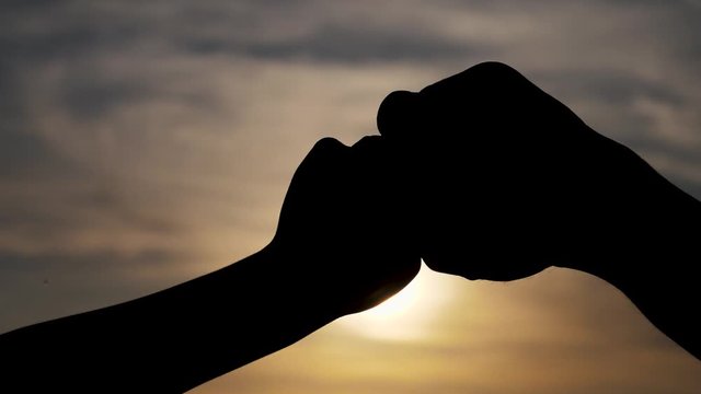 teamwork concept. of a human hand with bumping fist. Friends Friendship Fist Bump Togetherness Concept.lifestyle father and son teamwork hands silhouette at sunset