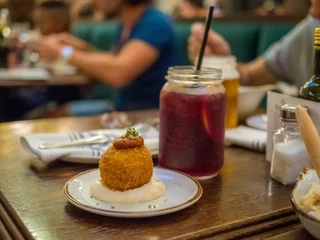 Spanish tapa called bomba served at a restaurant in Barcelona, Spain © mybixo