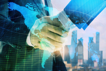 Double exposure of world map on cityscape background with two businessmen handshake. Concept of international business