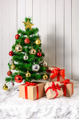 Christmas tree and ornaments with gifts boxes