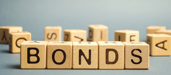 Wooden blocks with the word Bonds. A bond is a security that indicates that the investor has...