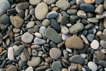 Gravel pattern of colored stones. Abstract nature pebbles background. Stone background. Sea peblles beach. Top view.
