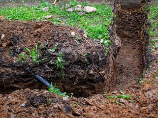 trench for cable laying in summer, Moscow.