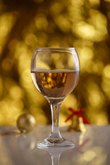 champagne glass on gold background with beautiful bokeh and Christmas toys
