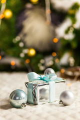 Three Pearl Christmas balls with colorful bokeh