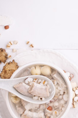 Tasty Four Tonics Herb Flavor Soup,Taiwanese traditional food with herbs,pork intestines on white wooden table,close up,flat lay,top view