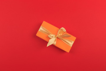 Gift box with ribbon and bow on color background and space for text. Top view - Image