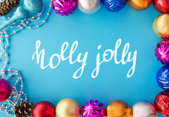 Holly jolly. Festive banner with colorful baubles and handwritten lettering. Merry Christmas and Happy New Year. Winter holidays and celebration. Greeting card, banner template.