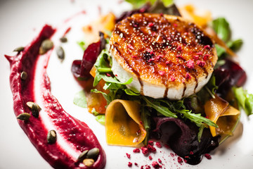 Grilled goat cheese salad served on a plate in restaurant