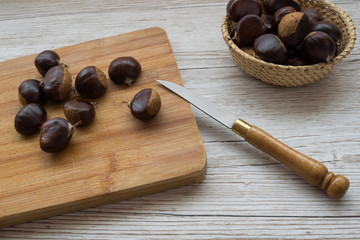 chestnuts on the cutting board and a knife