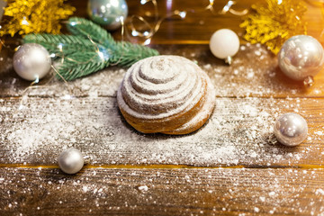 Obraz na płótnie Canvas Homemade traditional winter festive Bun on wooden background.