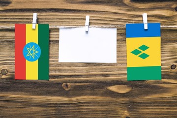 Hanging flags of Ethiopia and Saint Vincent And The Grenadines attached to rope with clothes pins...