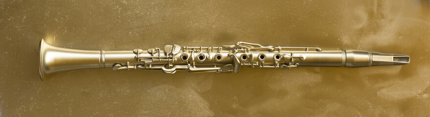 Obraz premium golden clarinet on a gold background