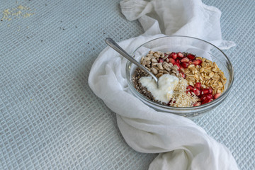 Healthy breakfast mood, muesli with raw pomegranate, sunflower and sesame seeds.
