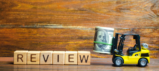 Forklift truck carries a bundle of dollars to inscription Review. Audit of business and enterprises, government agencies and services. Identification of financial embezzlement, violation of tax laws.