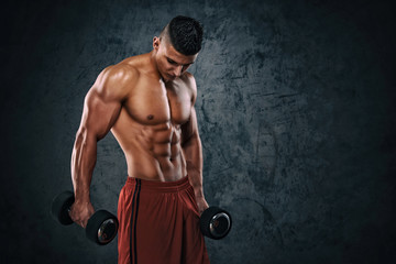 Fototapeta na wymiar Handsome Athletic Muscular Men Exercising With Weights