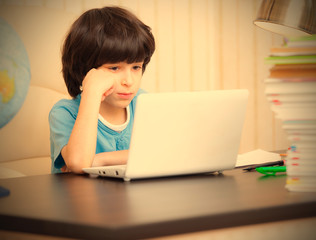 boy looking at a computer monitor