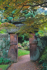 Fototapeta premium A traditional Chinese Garden with stone Gateway in a woodland setting
