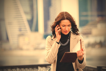 Fototapeta premium beautiful middle-aged woman using a smartphone