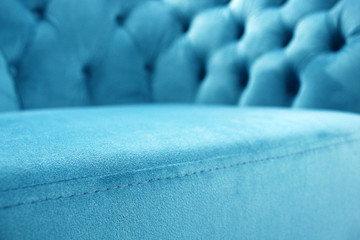 Detail of classical furniture, selective focus. Velour sofa close-up with part of the seat. Turquoise padded fabric upholstery of the sofa. Turquoise velvet with buttons on the upholstered furniture. - obrazy, fototapety, plakaty