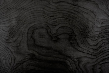 The texture is tinted in black plywood. Wooden background. Woodworking.